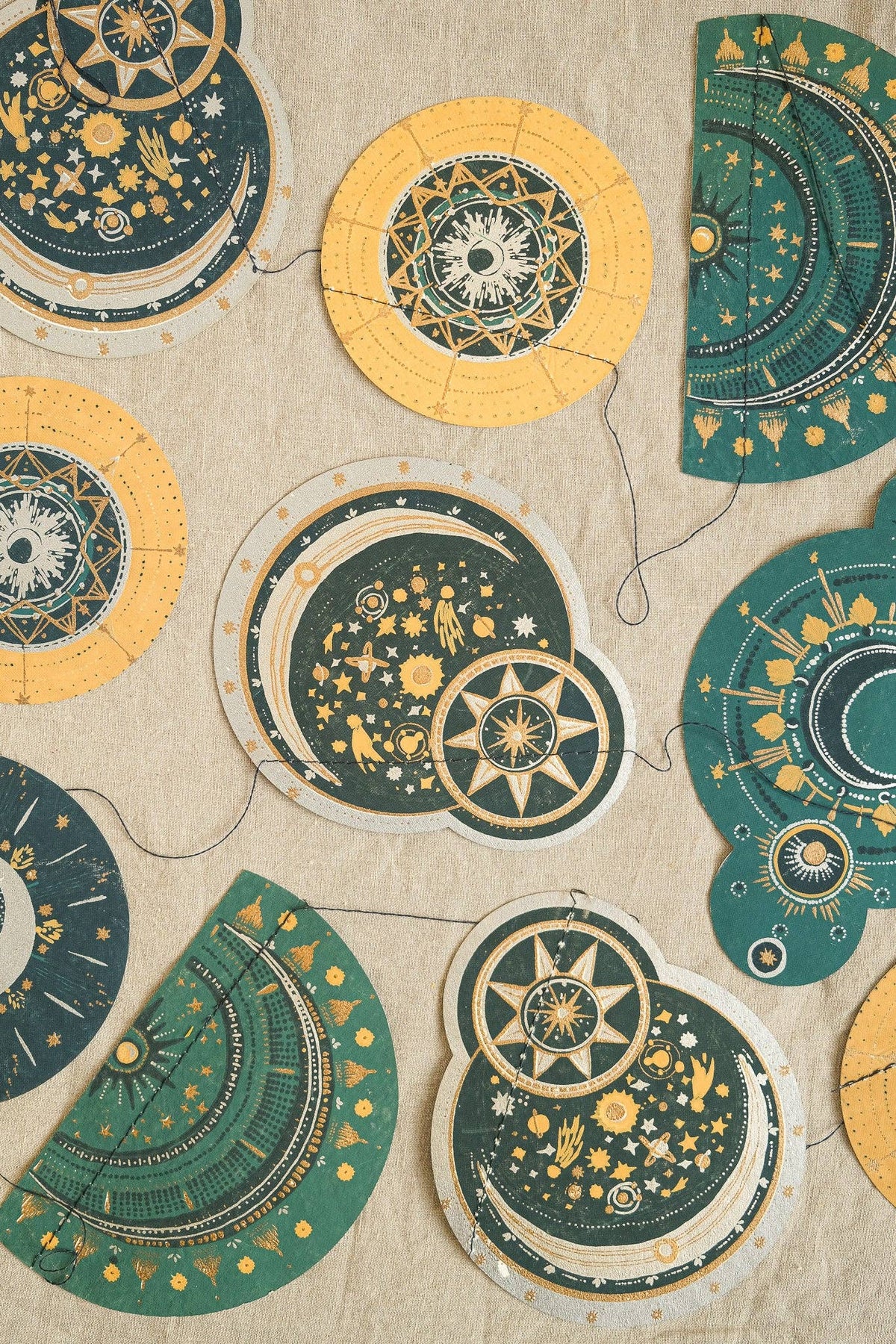 Decorative circular designs with celestial patterns on a beige background