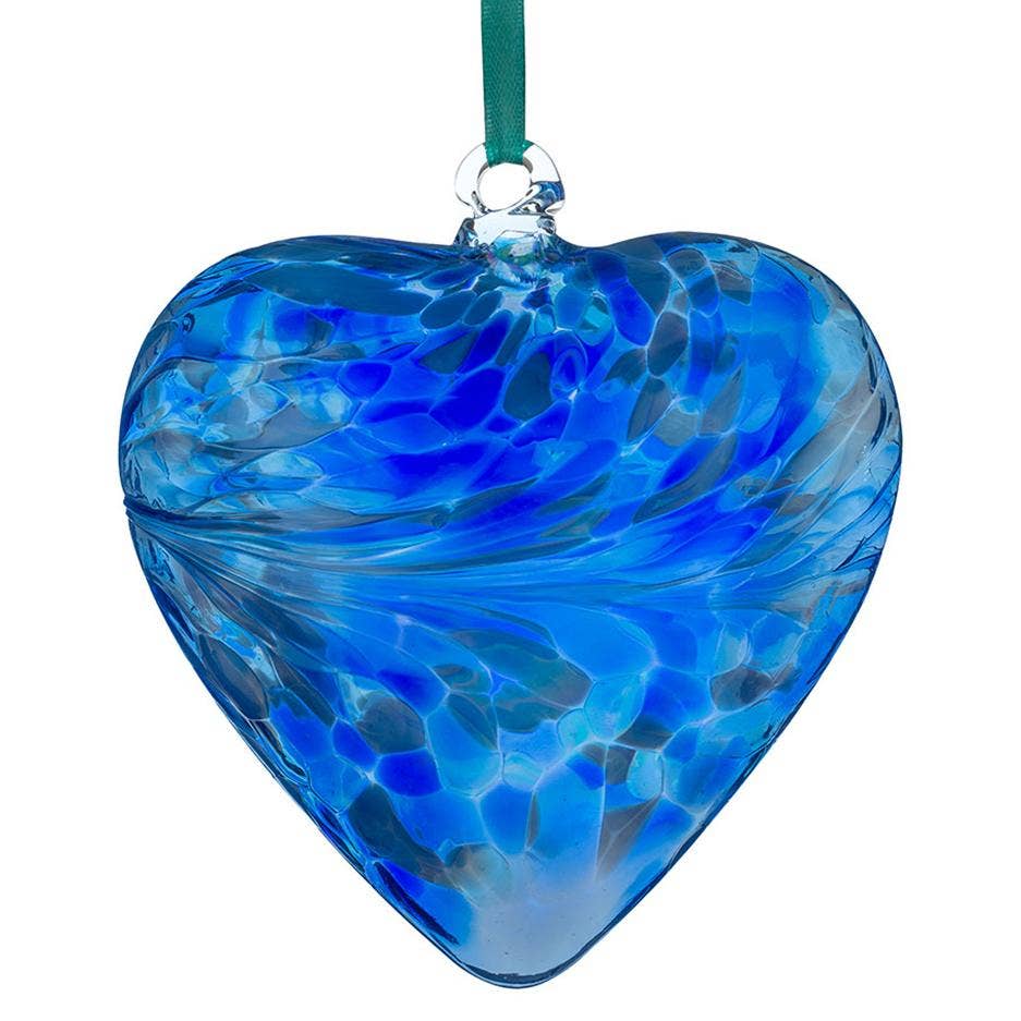 Blue glass heart ornament on a white background