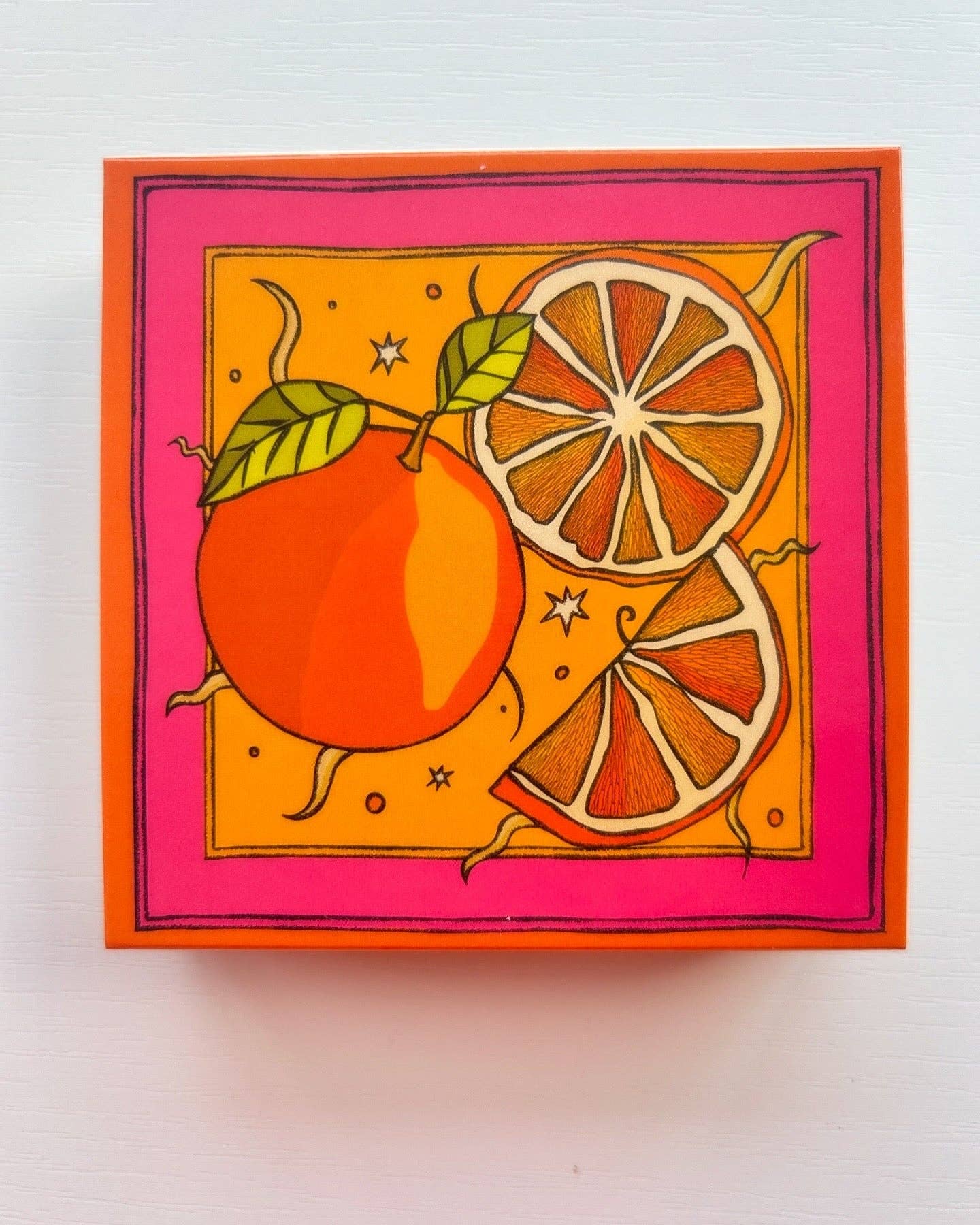 Matches in a beautifully box with illustration of oranges in colours of red and orange.