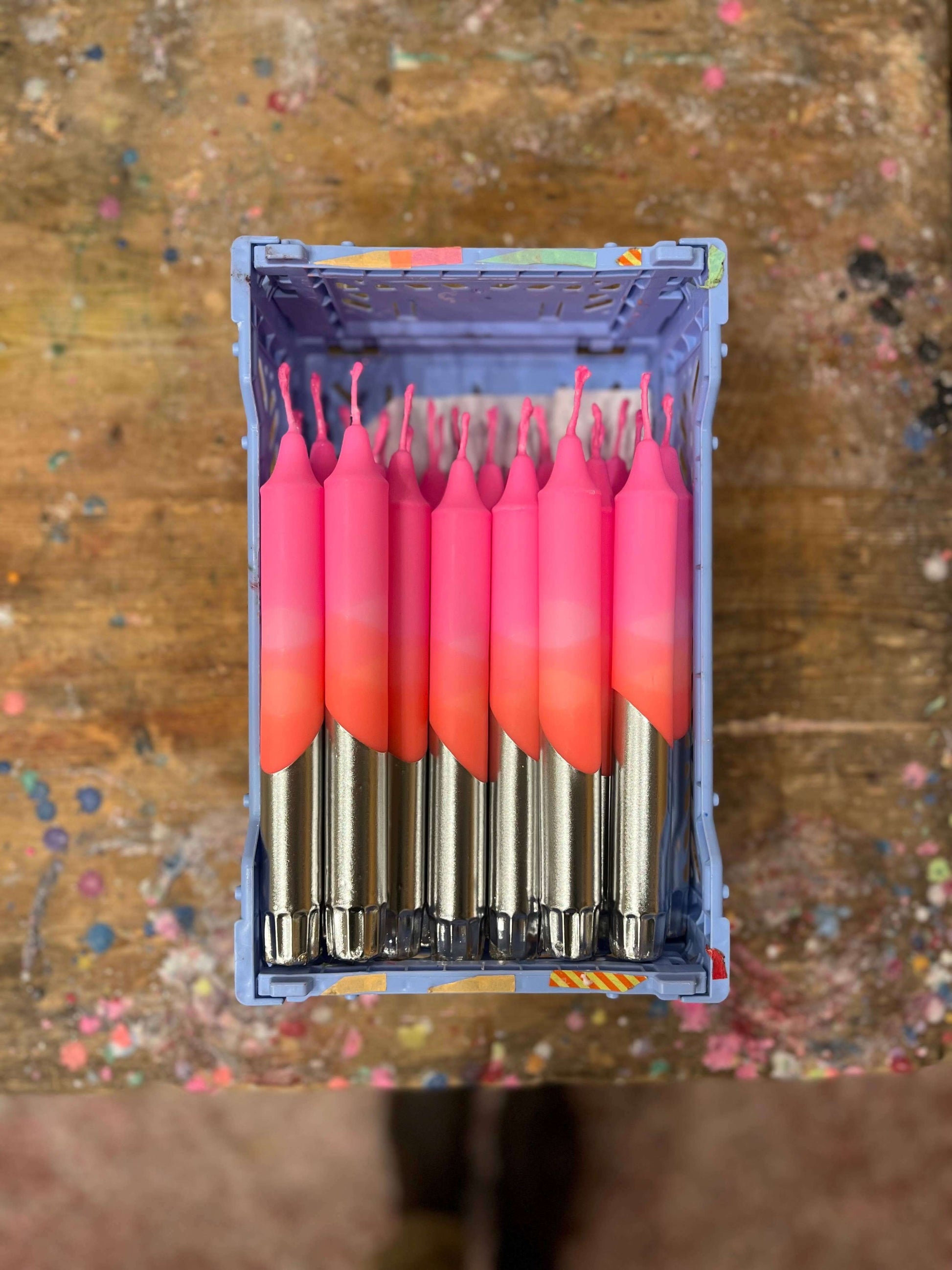 Bright pink. orange, gold dipped table candle.