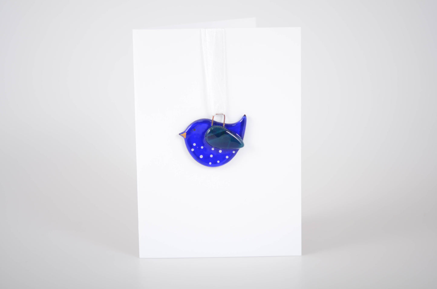 Blue polka dot bag with a silver clasp on a white background