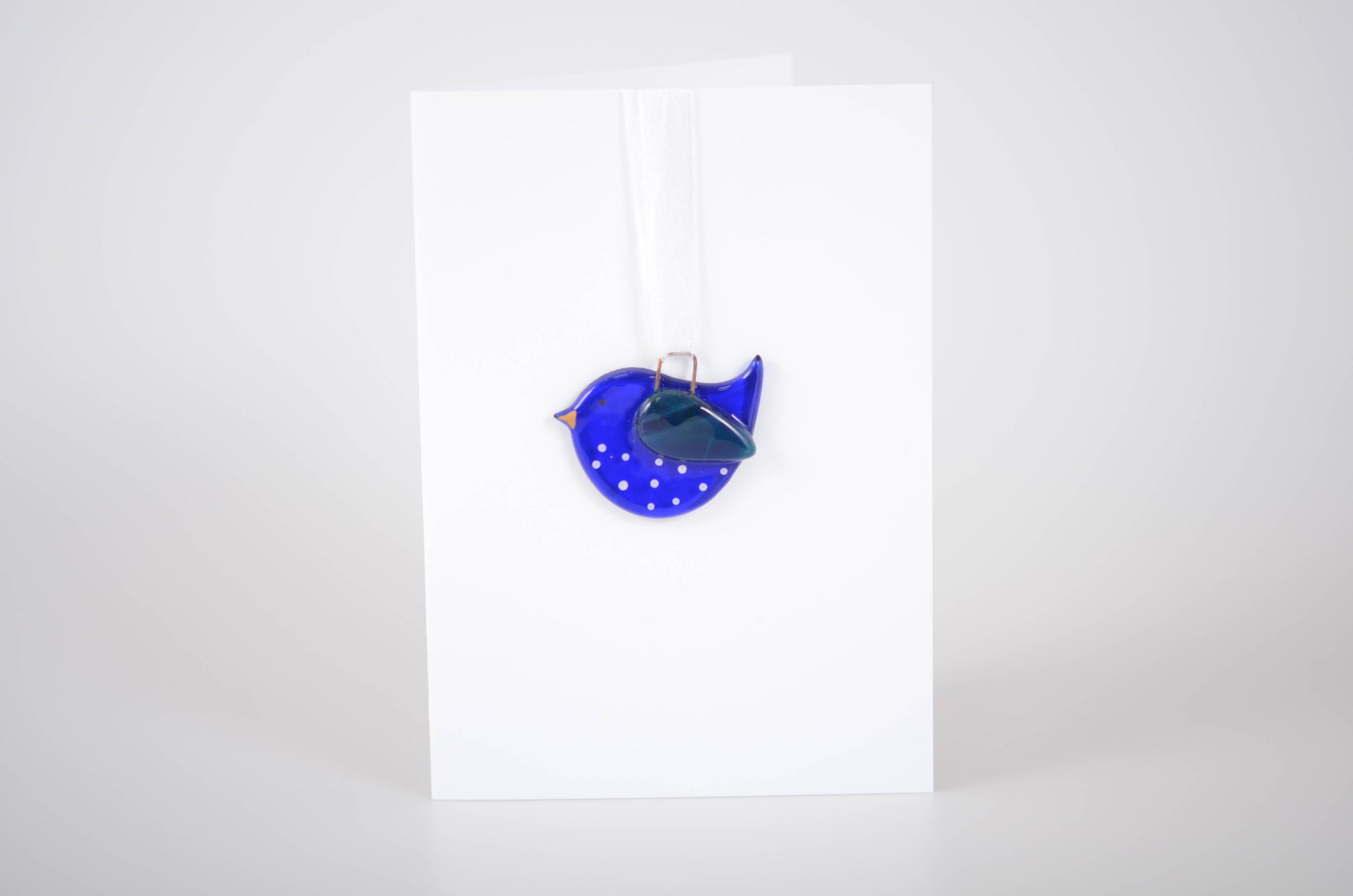 Blue polka dot bag with a silver clasp on a white background