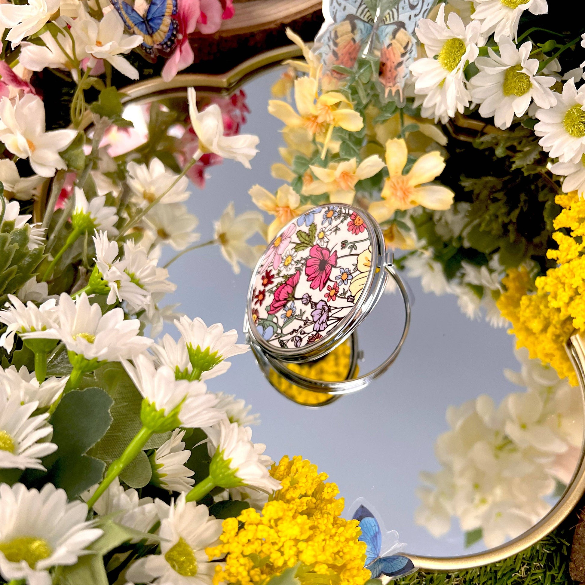 Small mirror compact with pretty floral design.