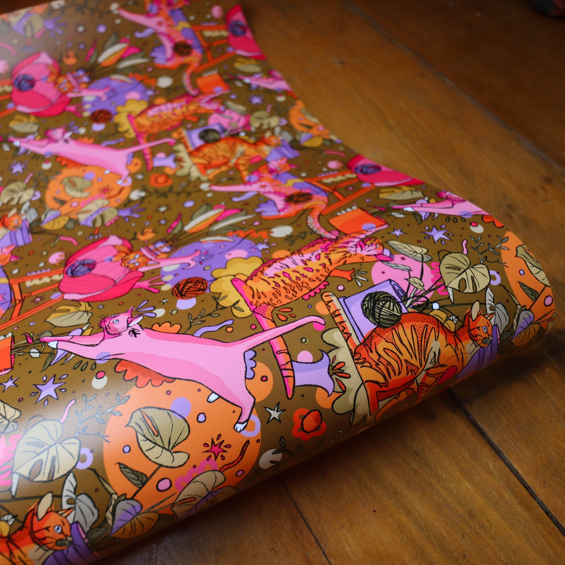 Bright gift wrap featuring cats, plants, feathers and plants.