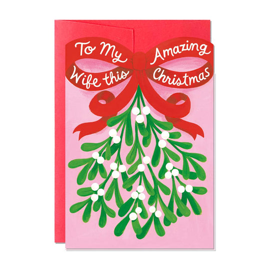 Christmas card.  Text is To my amazing wife this Christmas.  Illustrations of a bunch of mistletoe with a big red ribbon.