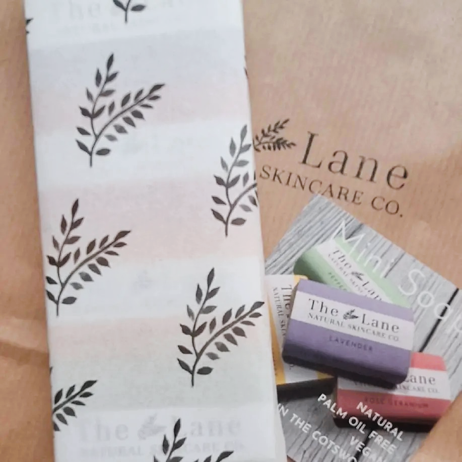 Lane Skincare Co. products including a soap bar and packaging on a wooden surface.