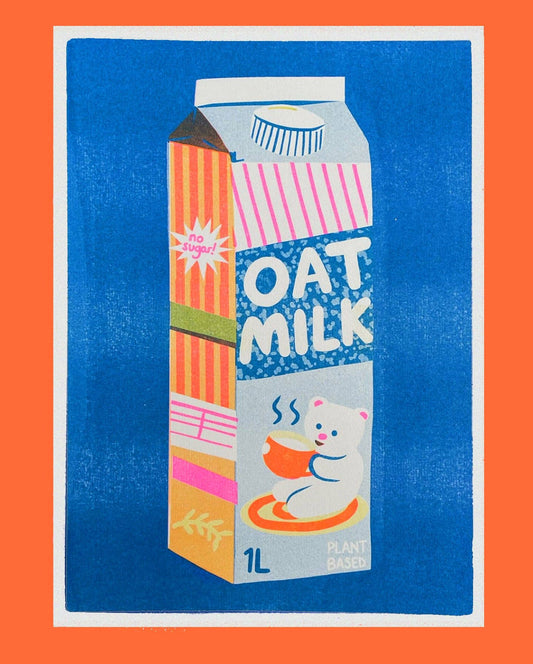 Carton of oat milk with colorful design on a blue background