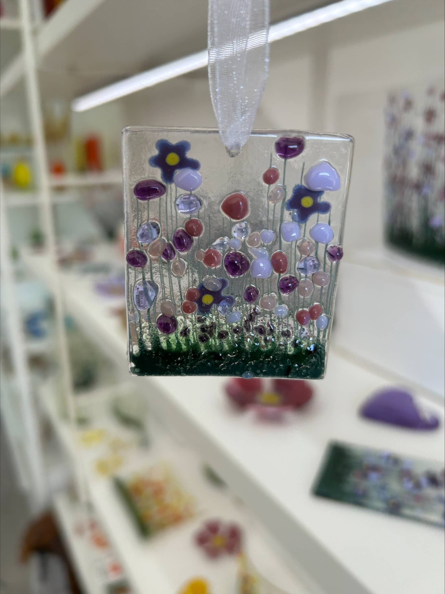 Decorative glass panel with colorful flowers on a blurred background
