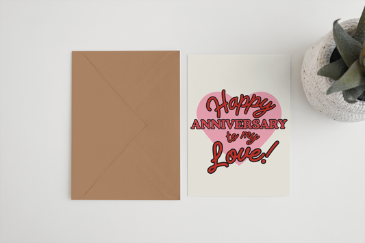 Greeting card with 'Happy Anniversary to my Love!' text on a white surface with a brown envelope.