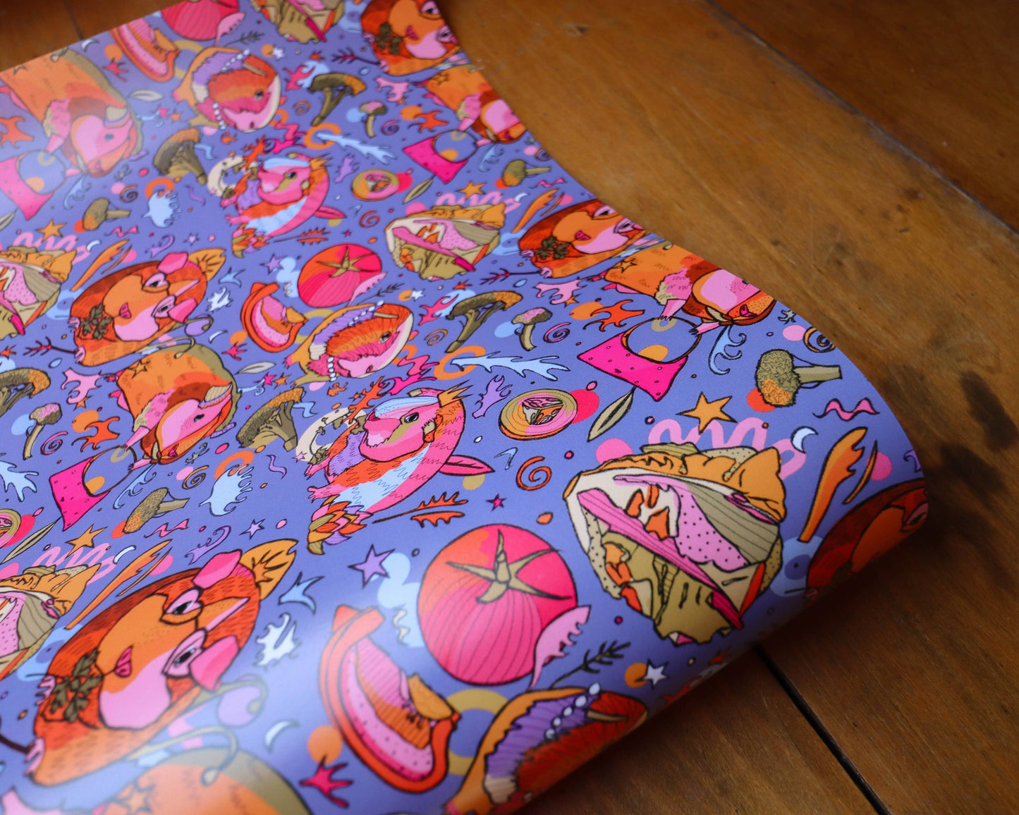 Colourful wrapping paper with guinea pigs wearing crowns.