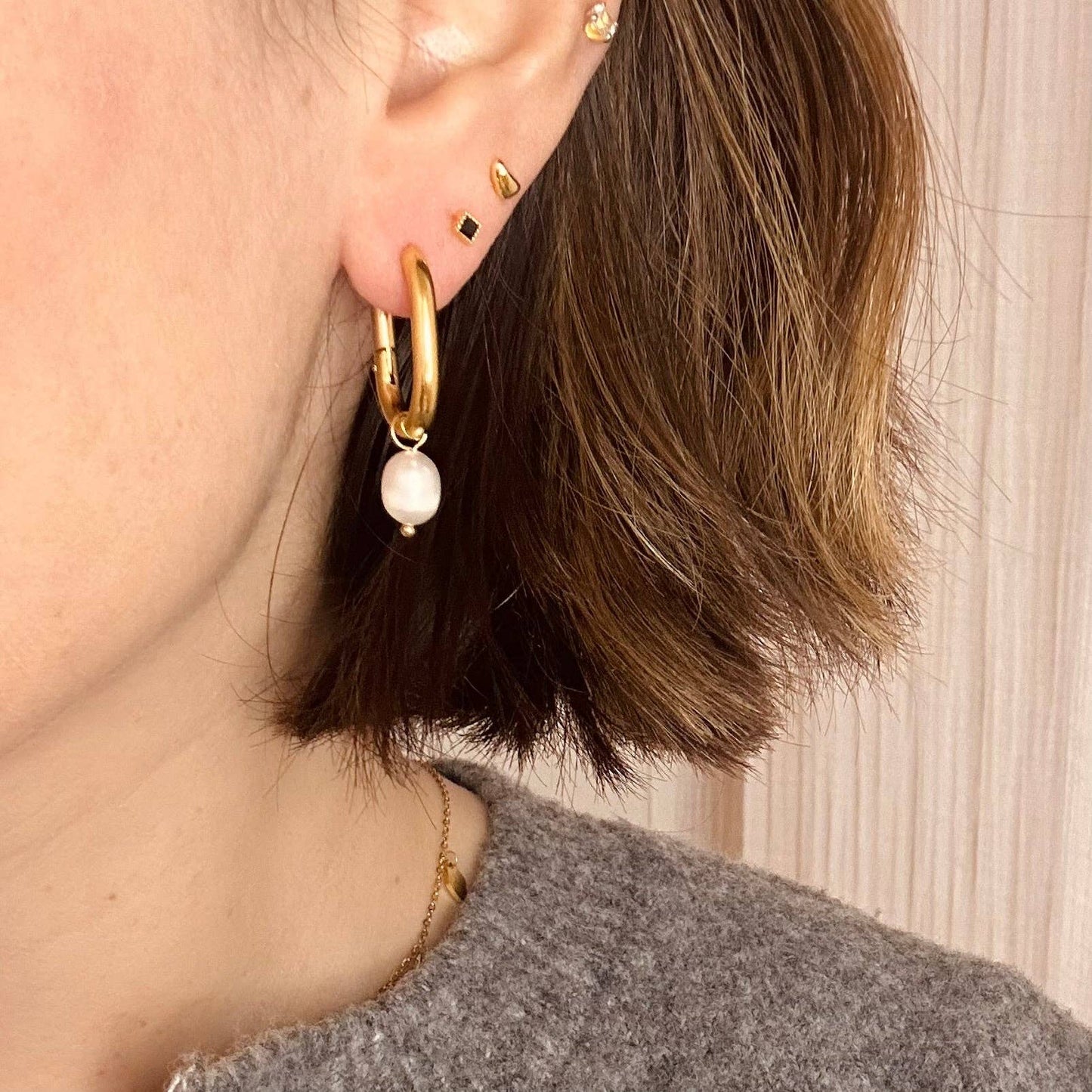 Gold plated hoop with detachable pearl charm.