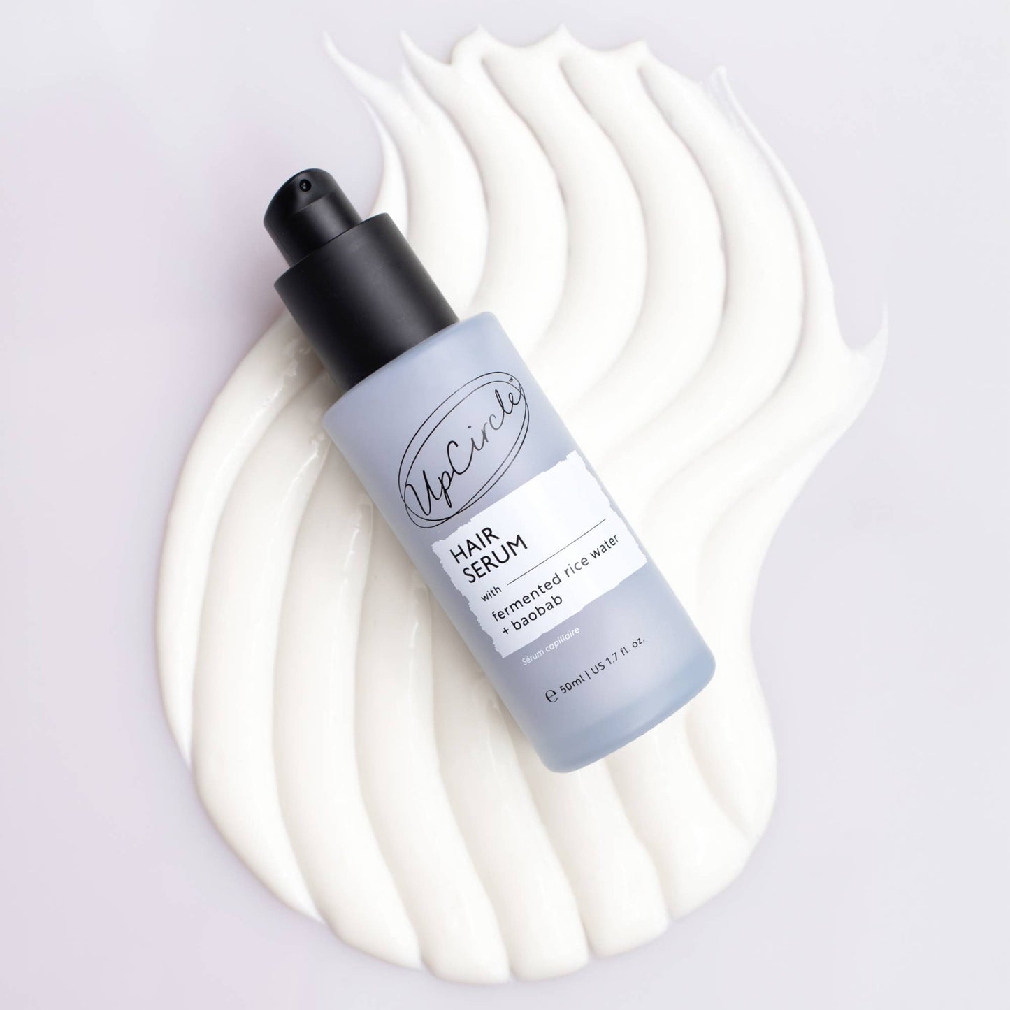 Hair serum bottle with a white background