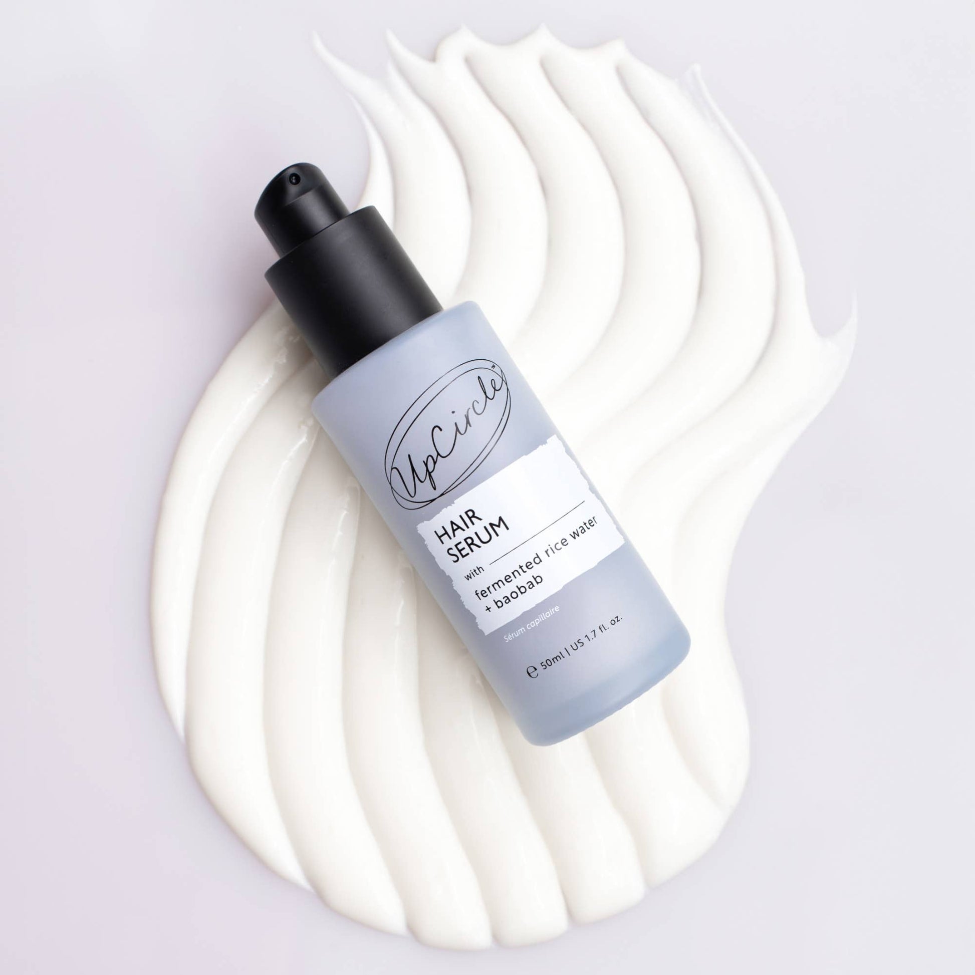 Hair serum bottle with a white background