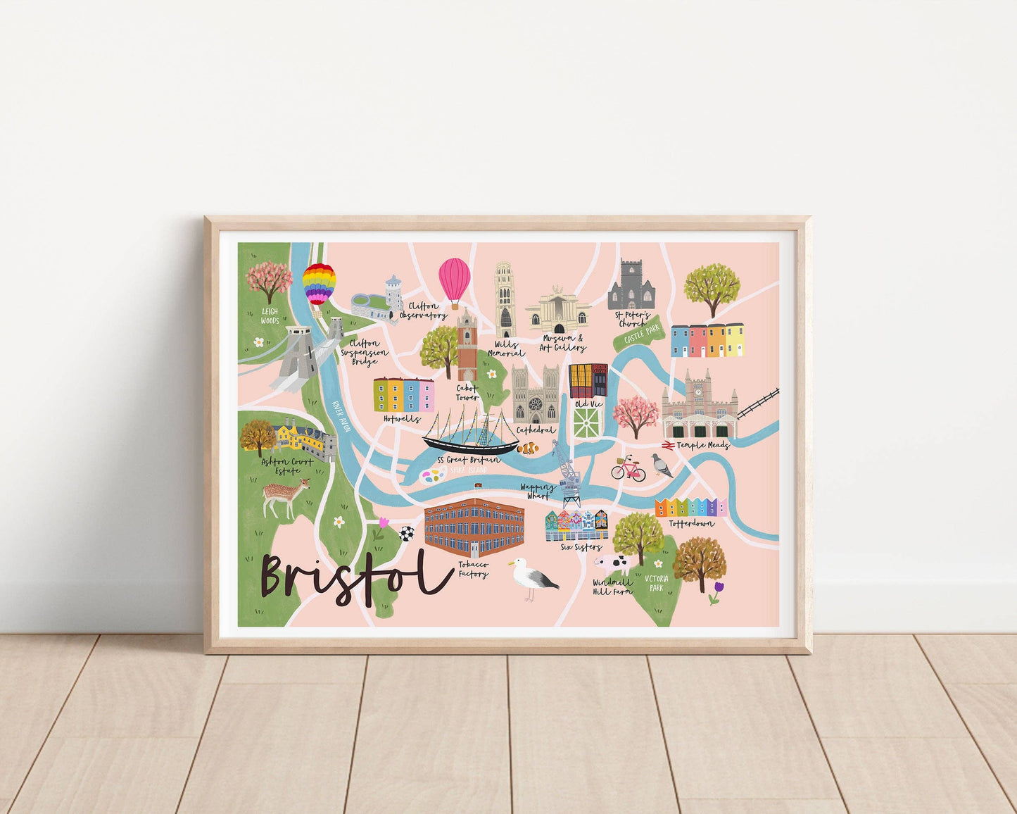 Framed colorful map of Bristol on a white wall.