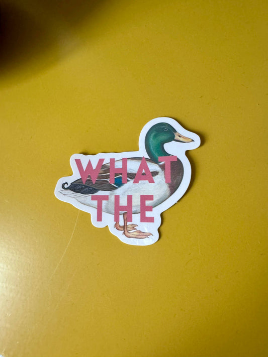 Sticker with a duck design and 'WHAT THE' text on a yellow background