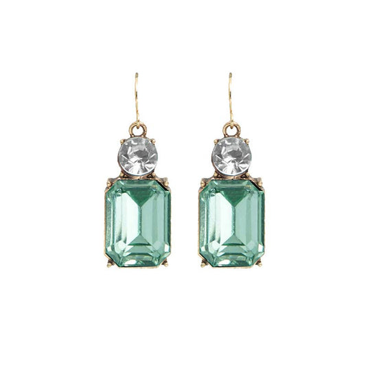 Pair of earrings with green gemstones on a white background