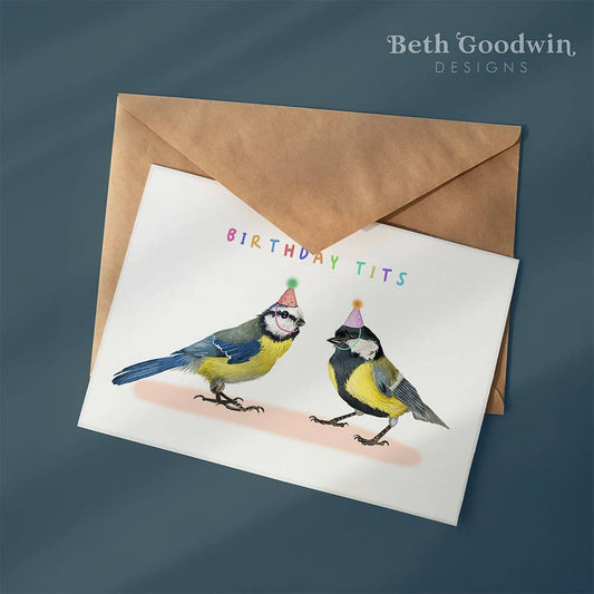 Greeting card with two birds wearing party hats and the text 'Birthday Tits' on a brown envelope, with 'Beth Goodwin Designs' branding.