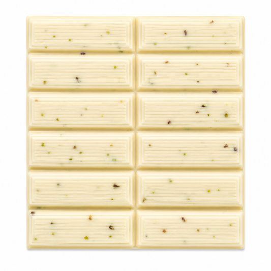 A square white chocolate bar with a grid of ten rectangular sections, each containing small scattered green and brown specks, shown on a plain white background.