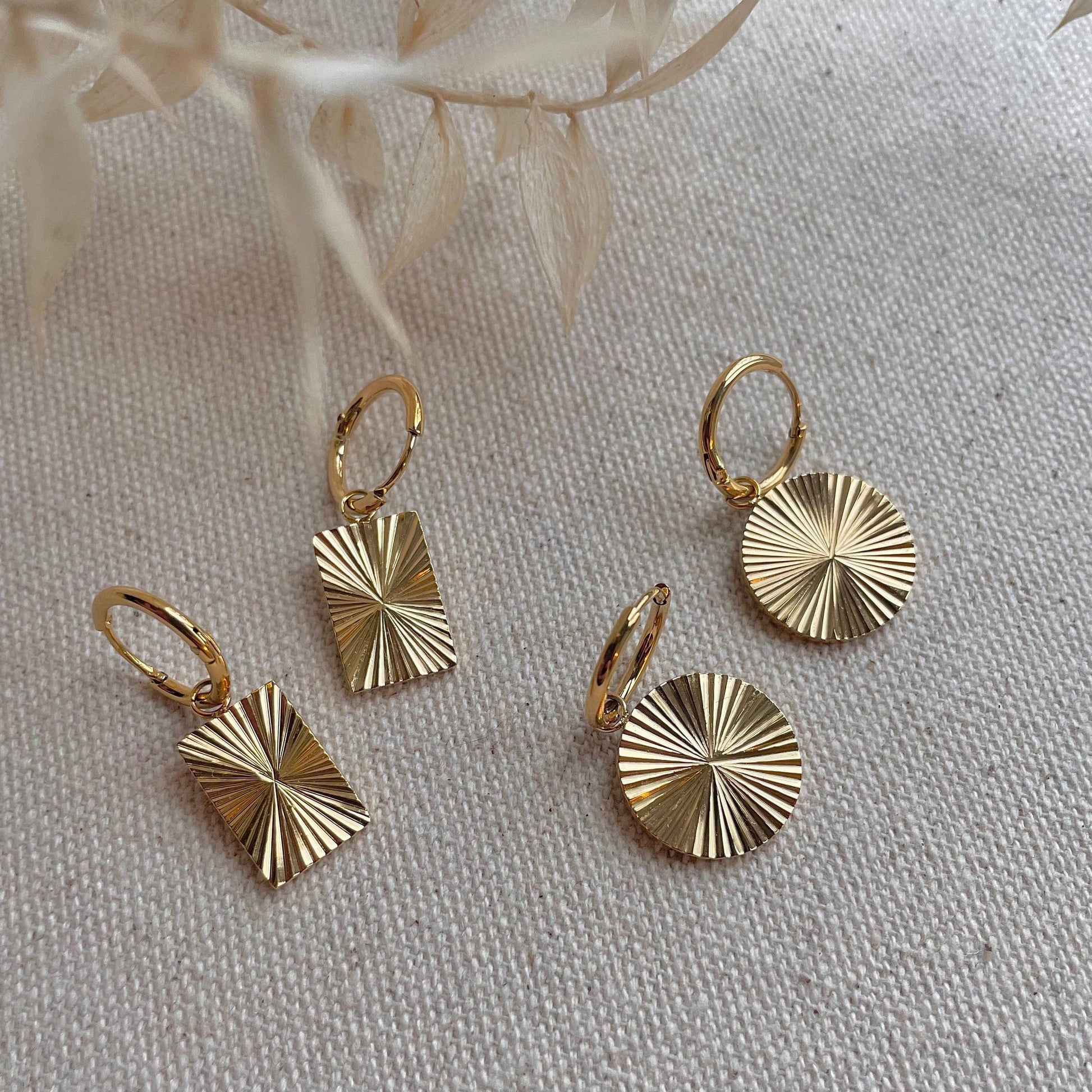 Round facetted gold plated earrings on hoops.