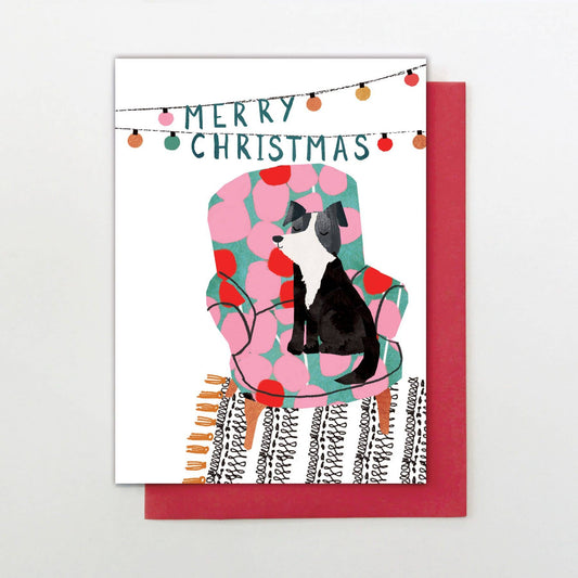 Christmas card with a dog on a pink chair and 'Merry Christmas' text.