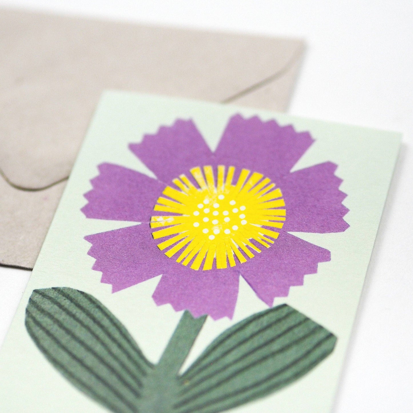 Small Greetings card with a little purple flower.  Blank inside.