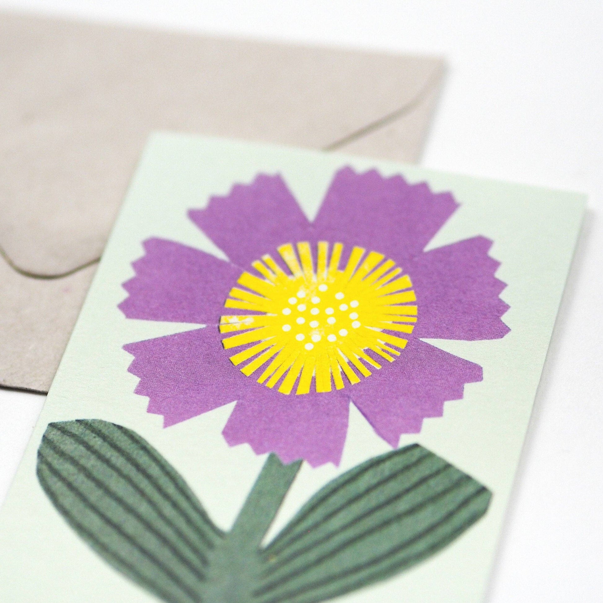 Small Greetings card with a little purple flower.  Blank inside.