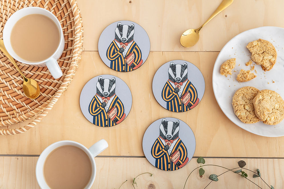Four round coasters featuring an illustration of a badger in a striped jacket and red bow tie, enjoying a little biscuit.