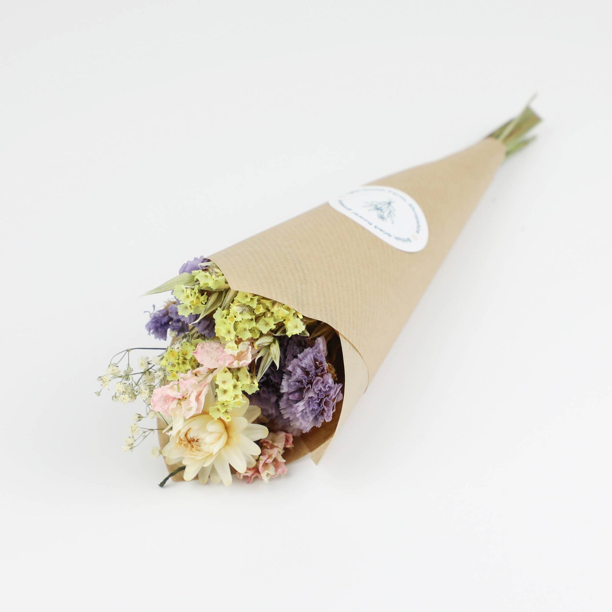 Bouquet of flowers wrapped in brown paper on a white background