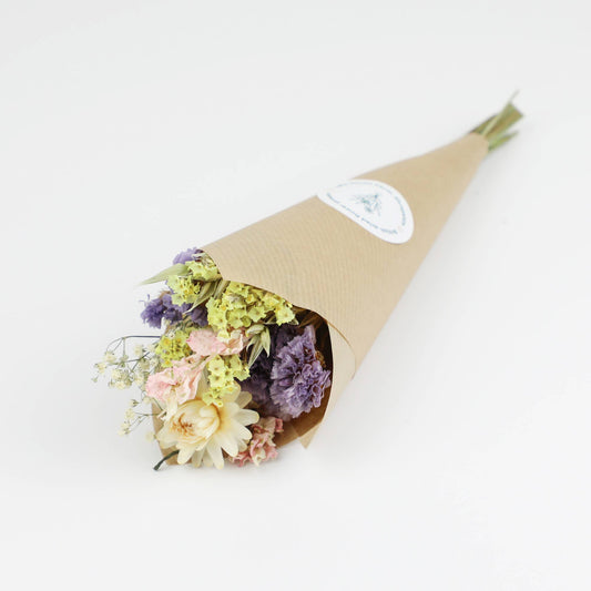 Bouquet of flowers wrapped in brown paper on a white background
