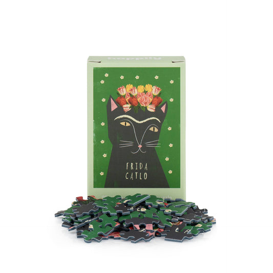 Frida Catlo puzzle with packaging featuring a black cat illustration and flowers on a green background.