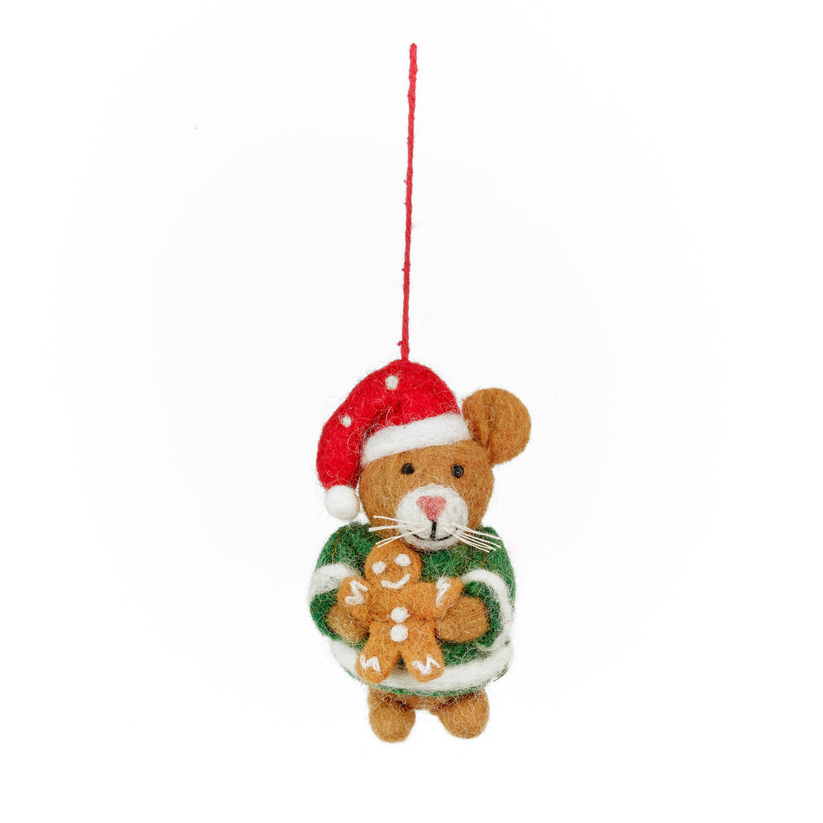 A small felt teddy bear Christmas ornament wearing a red Santa hat and green sweater with gingerbread cookies, hanging by a red string on a white background.