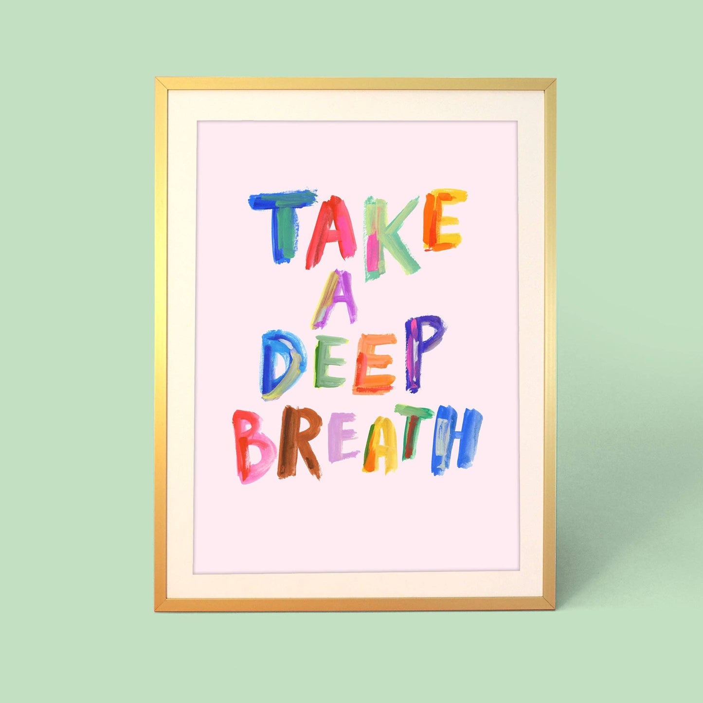 Framed artwork with 'Take a Deep Breath' text in colorful letters on a light green background