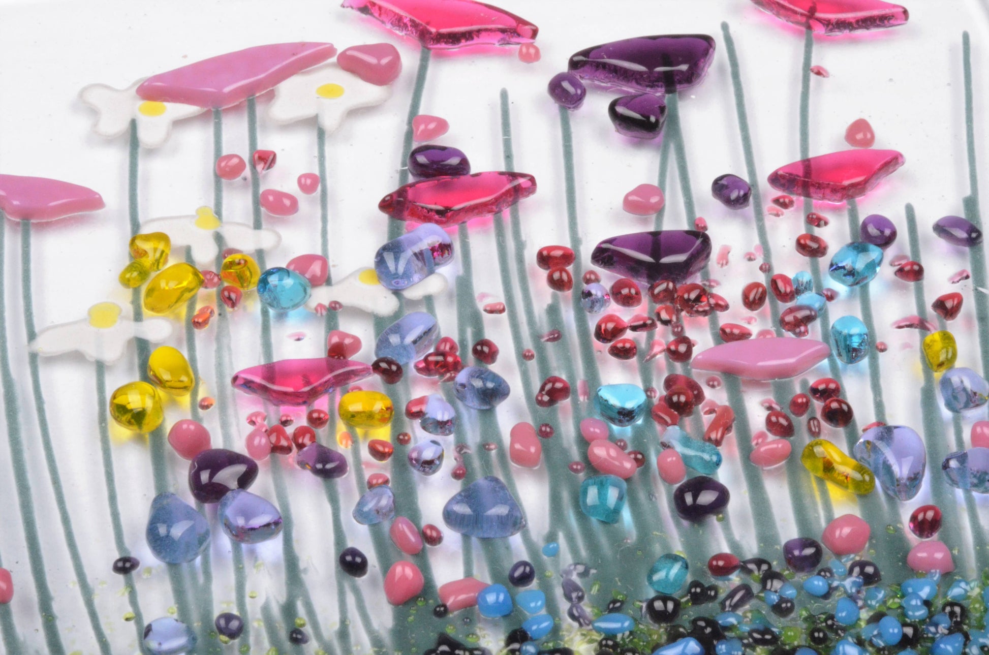 Colorful glass art piece with various shapes and colors on a white background