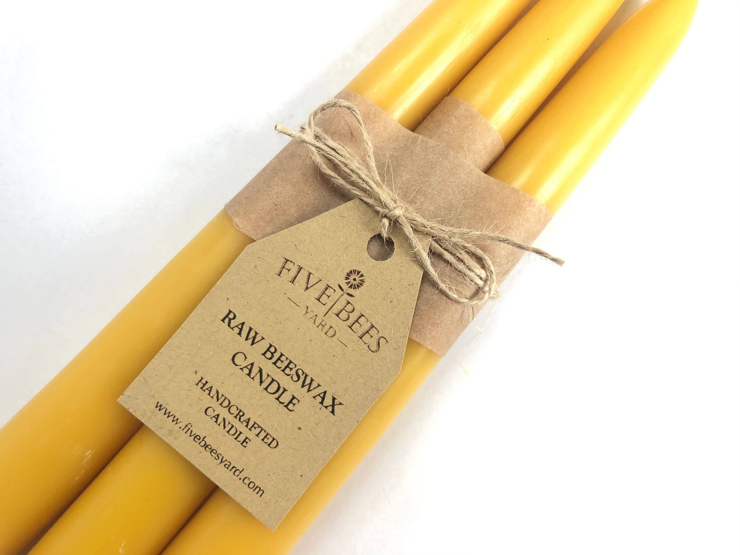Three yellow candles tied with brown string and a FiveBees tag on a white background