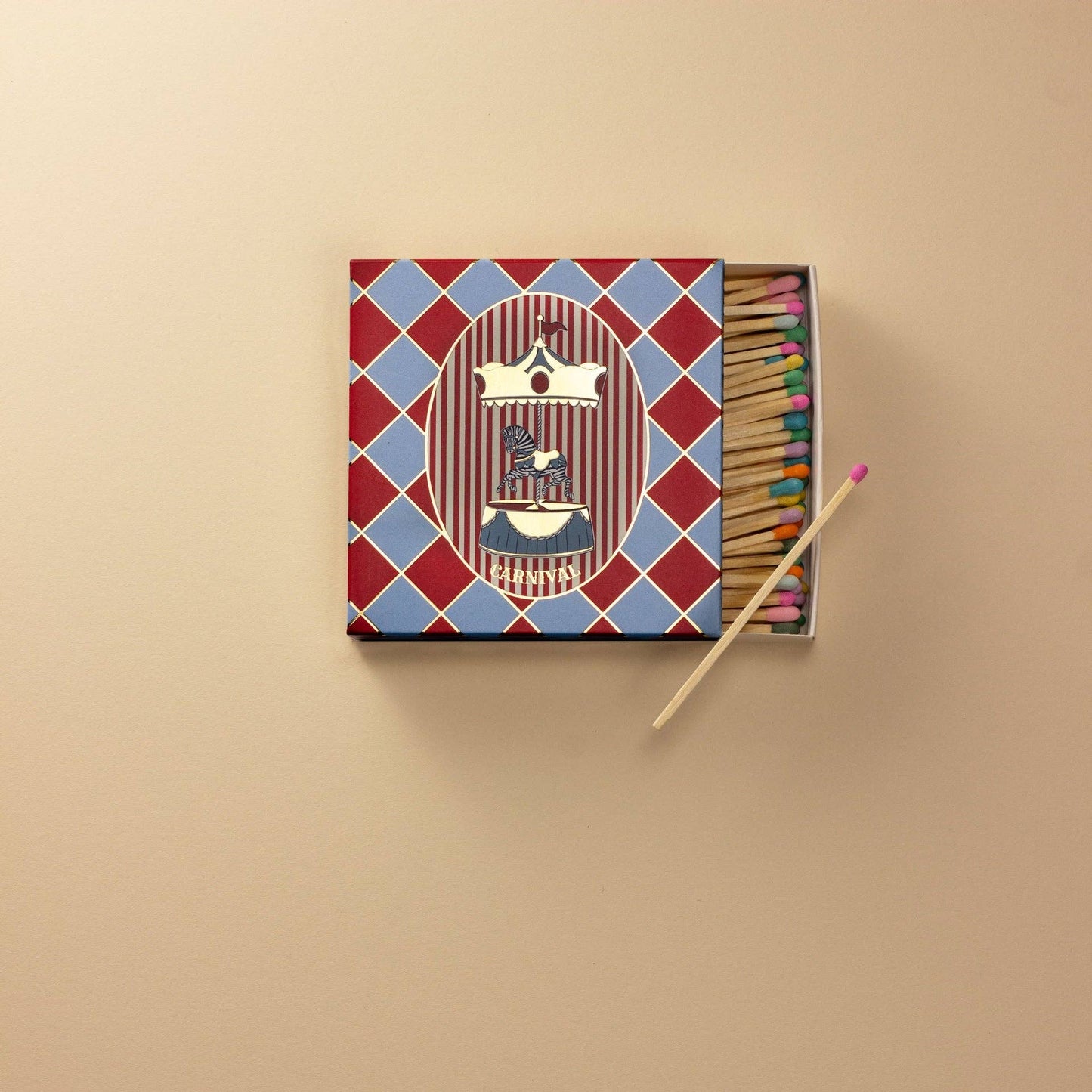 Matchbox with colorful matches on a beige background