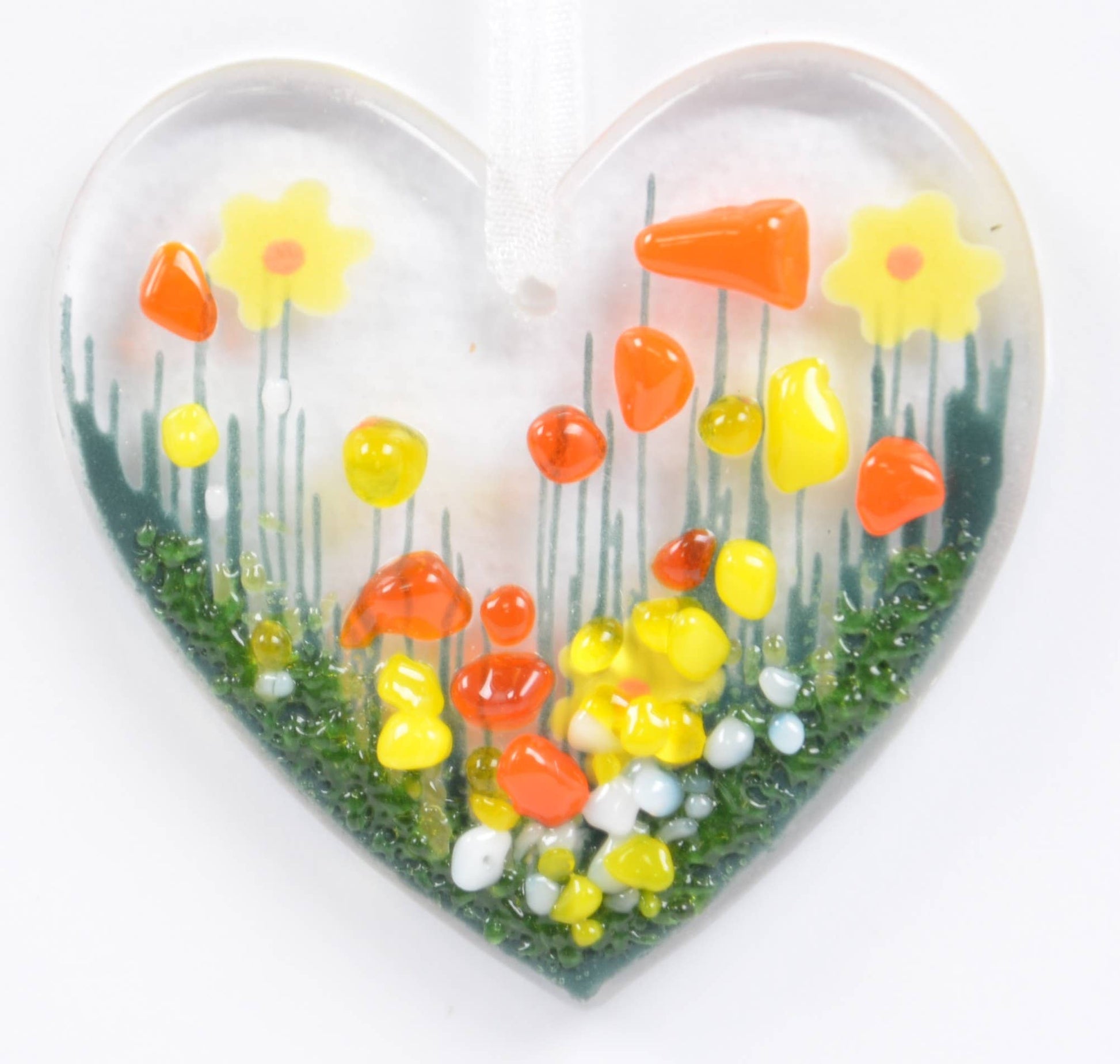 Heart-shaped object with a floral design on a white background