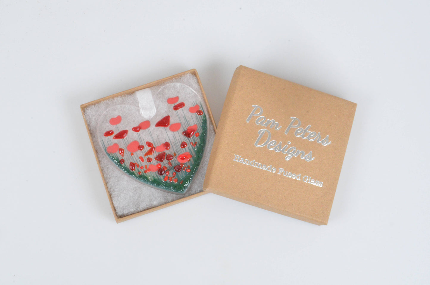 Heart-shaped ornament in a box with 'Piper Paterson Designs' branding on a white background