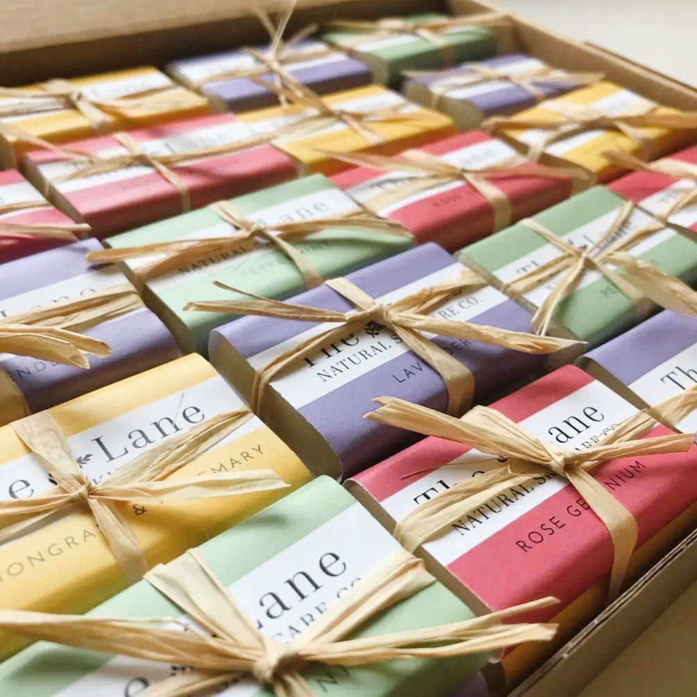 Assorted colorful soap bars with visible branding in a box