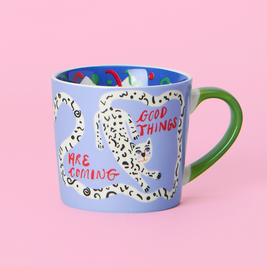 Mug with a leopard design and text 'Good Things Are Coming' on a pink background