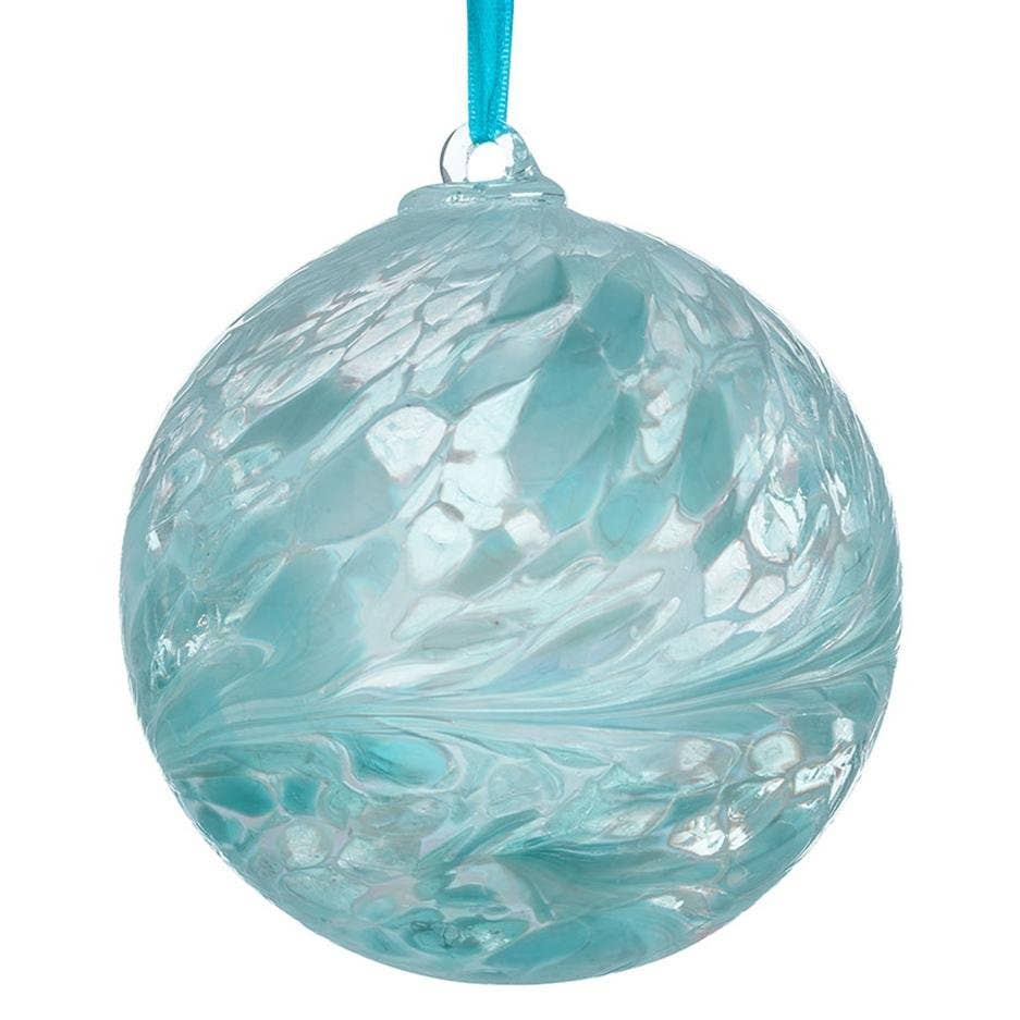 Turquoise glass ornament with marbled pattern on a white background