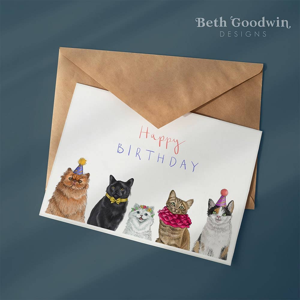 Birthday card with illustrations of cats wearing party hats and the text 'Happy Birthday' by Beth Goodwin Designs.