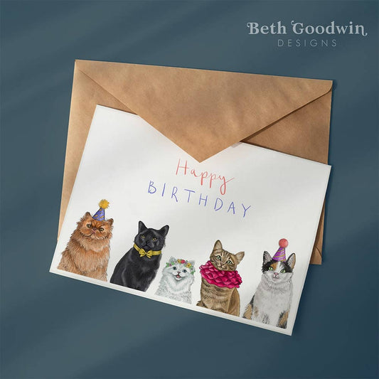 Birthday card with illustrations of cats wearing party hats and the text 'Happy Birthday' by Beth Goodwin Designs.