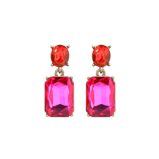 Pair of earrings with red and pink gemstones on a white background