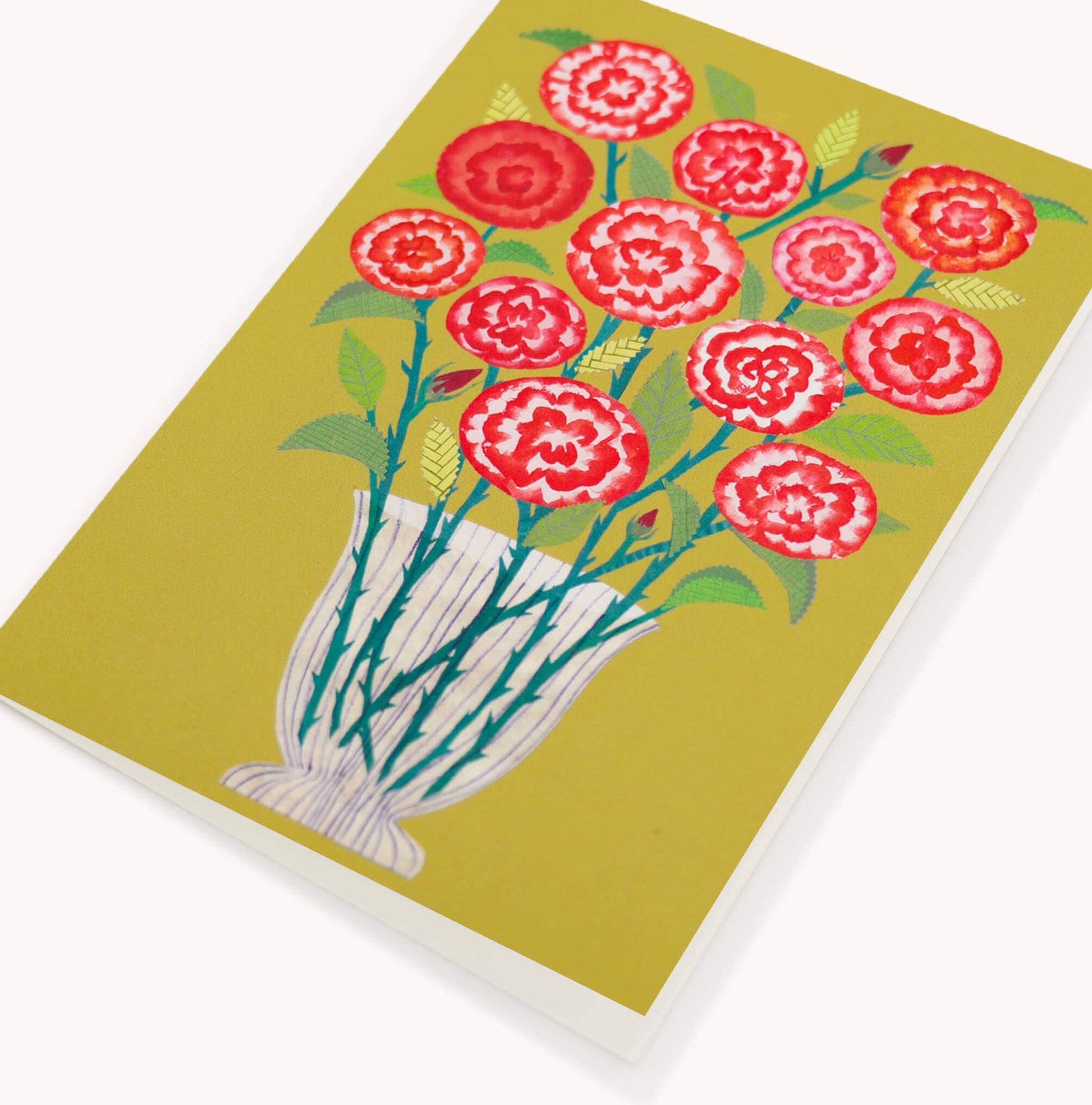 Notebook with red floral design on a green background