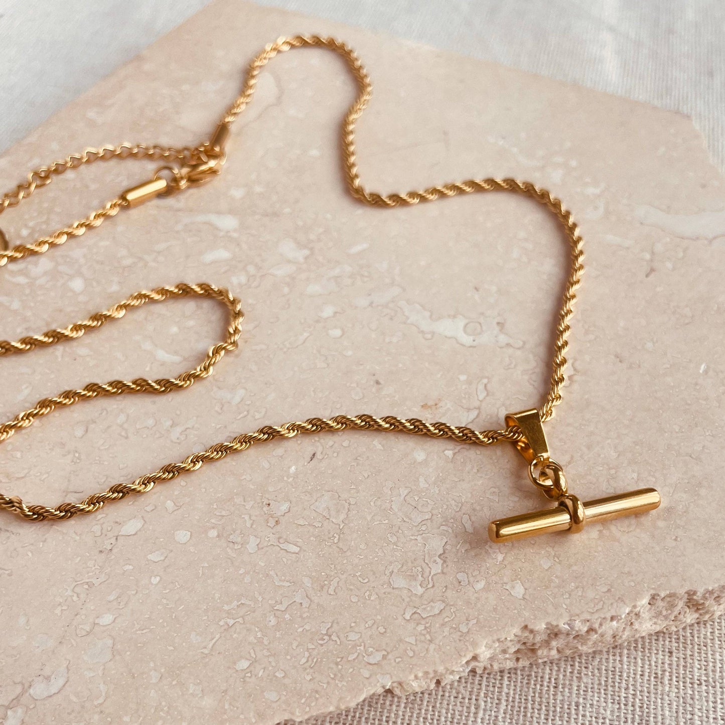 Gold plated bar pendant on a twisted chain.