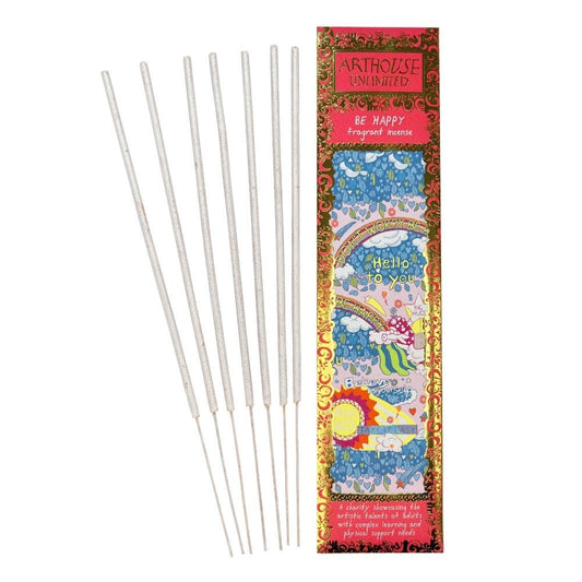 Six silver taper sticks arranged next to their colorful packaging box on a plain white background. The box features a vibrant design with the brand name 'Arthouse Unplugged' and the scent name 'Be Happy'.