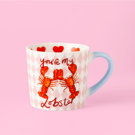 Mug with lobster design and text on a pink background
