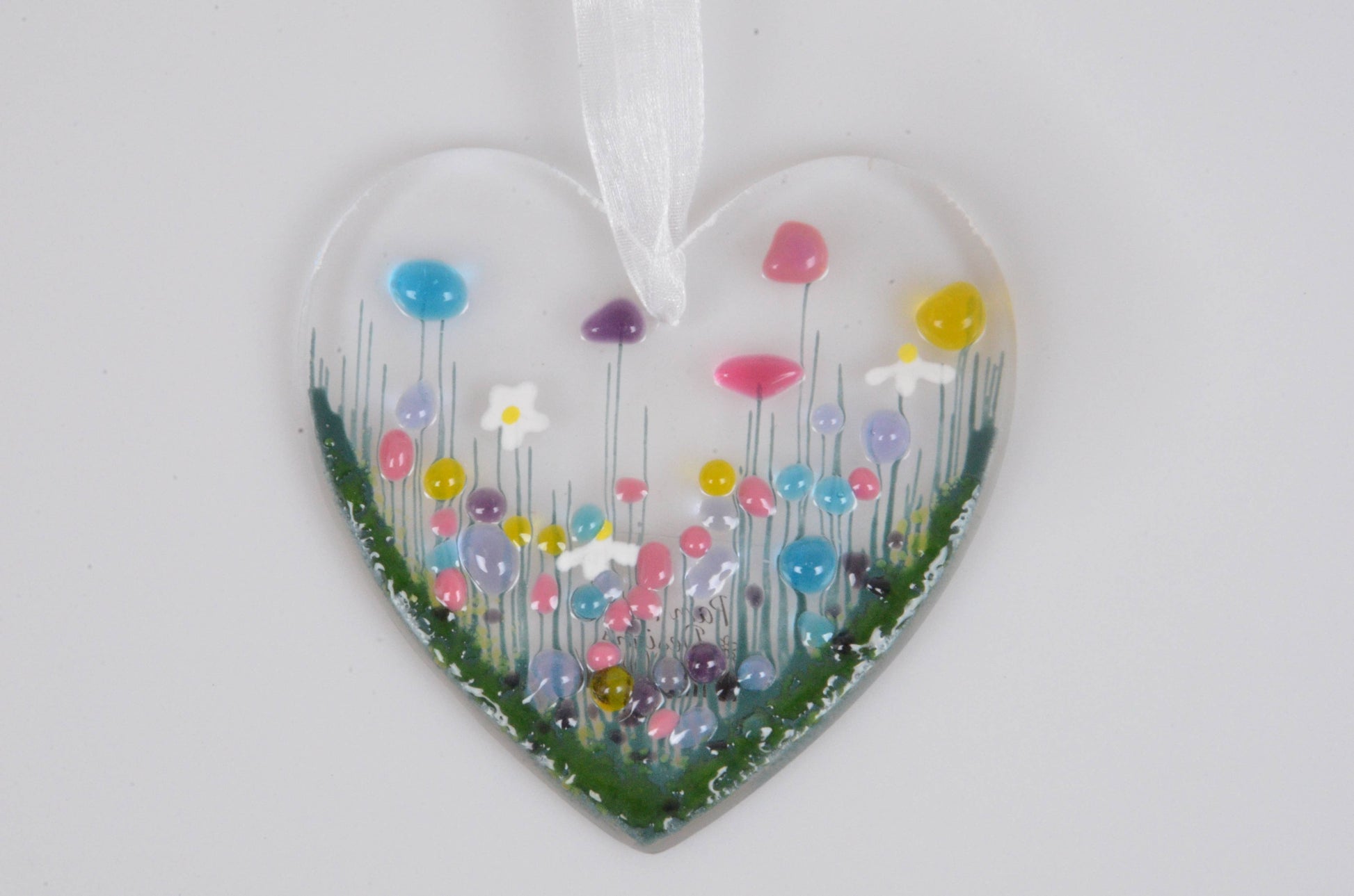 Heart-shaped ornament with colorful flowers on a white background
