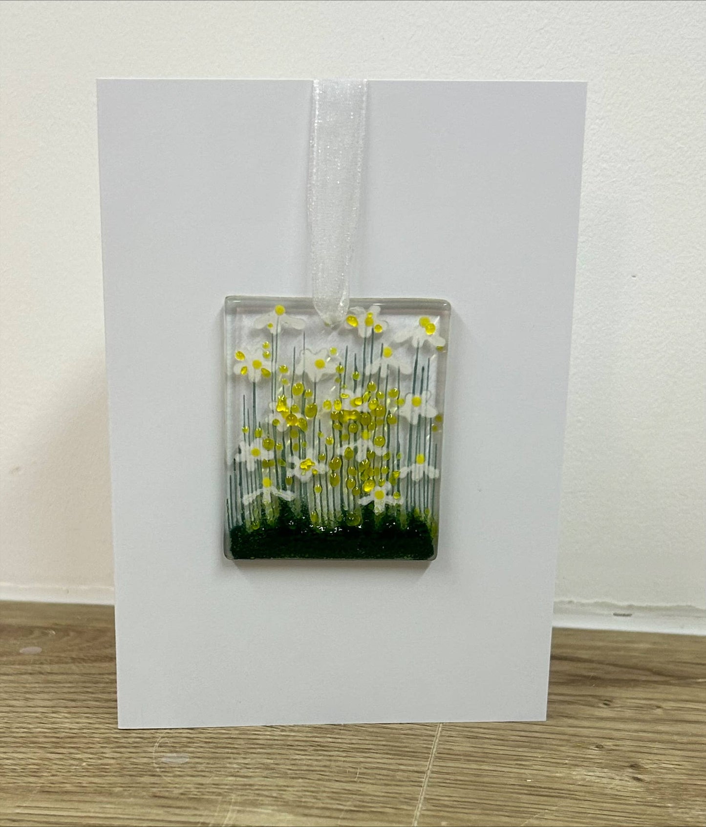 Card with a fused glass panel featuring flowers on a white background