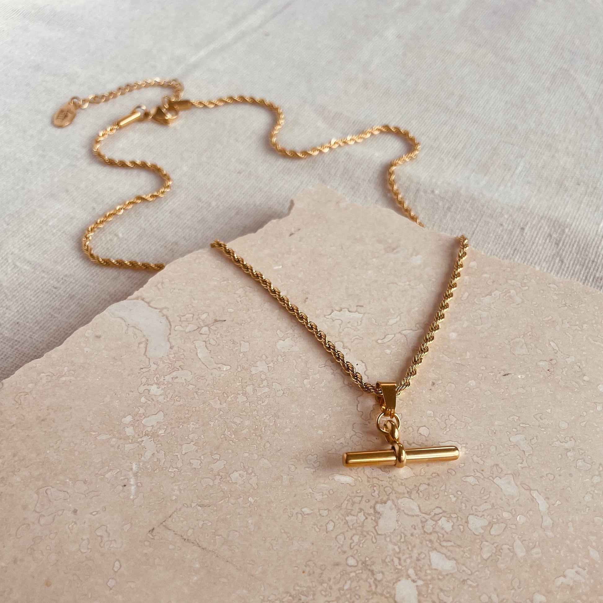 Gold plated bar pendant on a twisted chain.